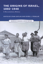 Black and white image of a group of farmers carrying implements in an early Israeli farm