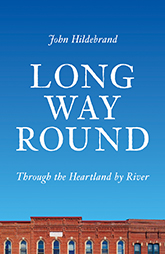 Long Way Round: cover art of a blue sky above a red brick building, the title text taking up most of the space.