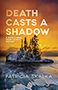 Death Casts a Shadow: cover depicting an island in a lake during the winter, an orange sunset filling the sky behind tall pine trees.