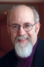 Photo of Stuart Levitan shows him in with glasses and a distinguished beard. 